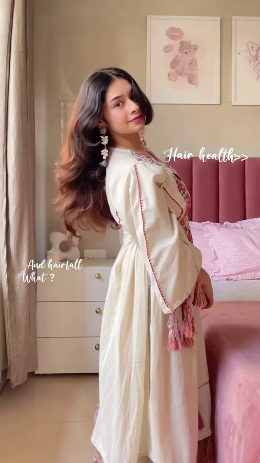 Cream-Colored Embroidered Traditional Dress with Colorful Circular Motifs and Pink Tassel Accents