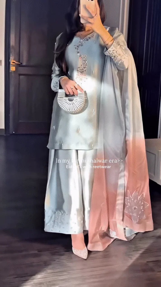 Showcasing the Fluid Drape and Intricate Silver Beadwork of a Light-Toned Formal Outfit