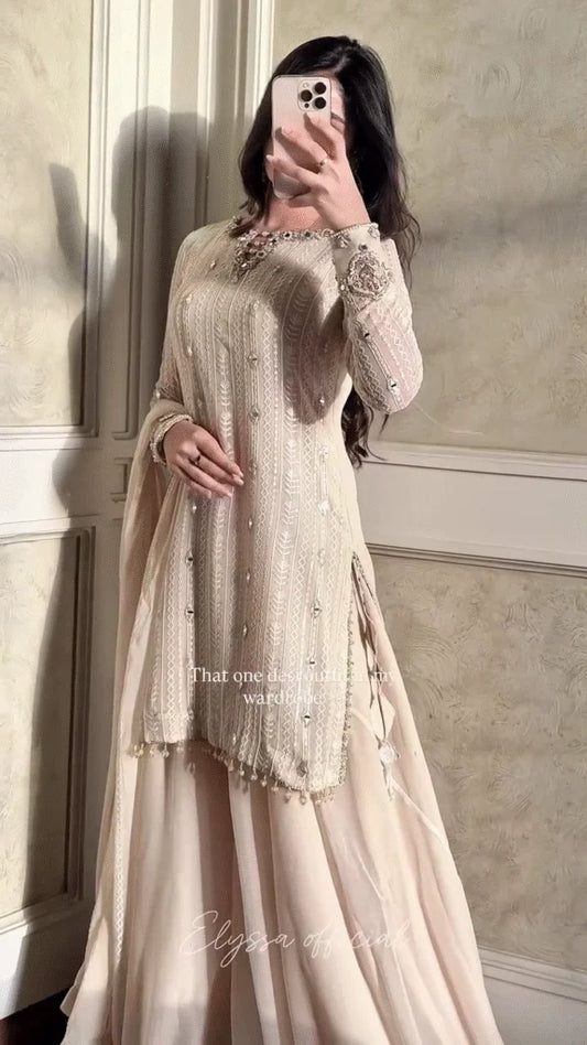 A Monochromatic Ensemble Featuring Delicately Flowing Fabrics and Sparkling Mirror Work